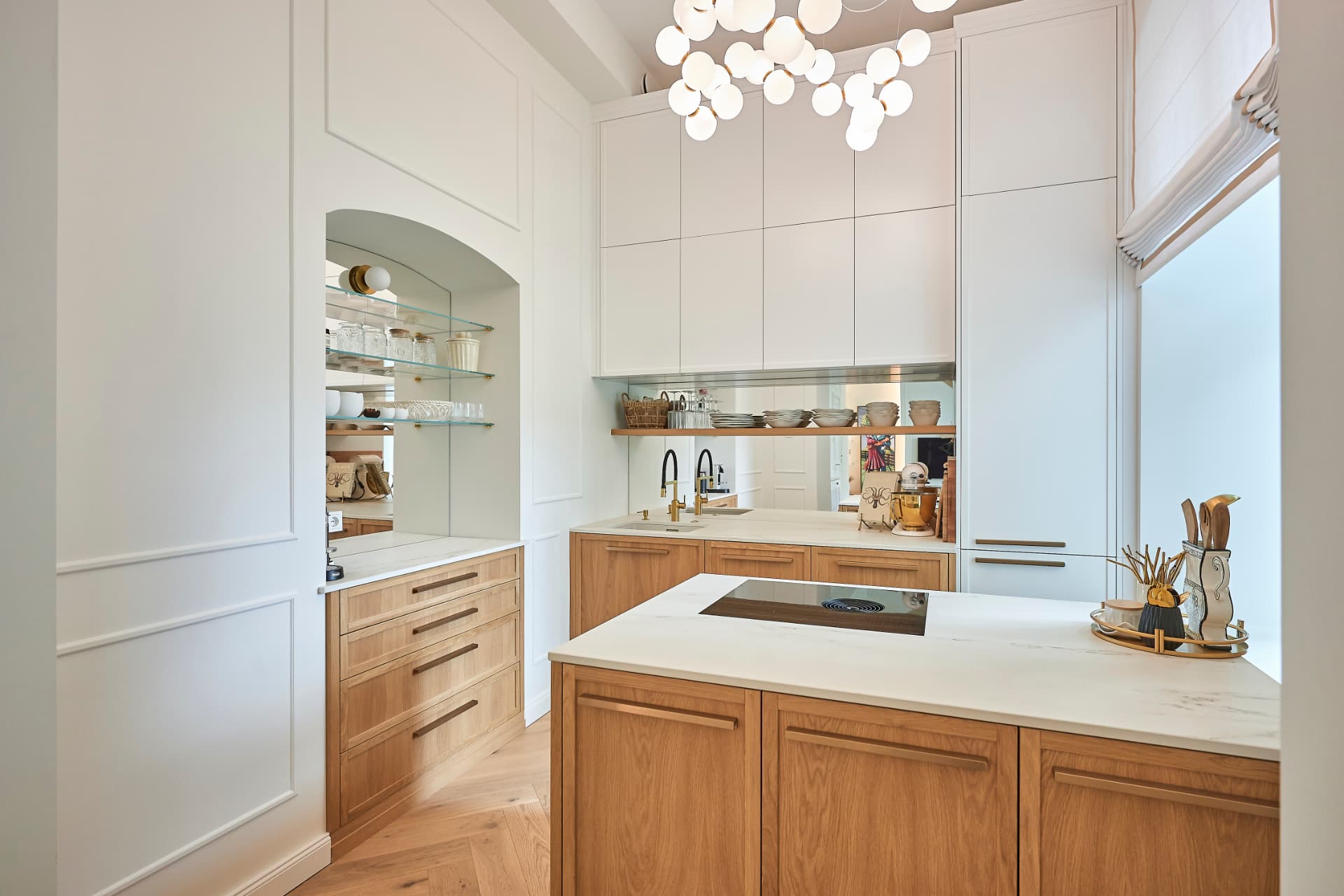 White bespoke kitchen furniture with a wooden island and integrated appliances