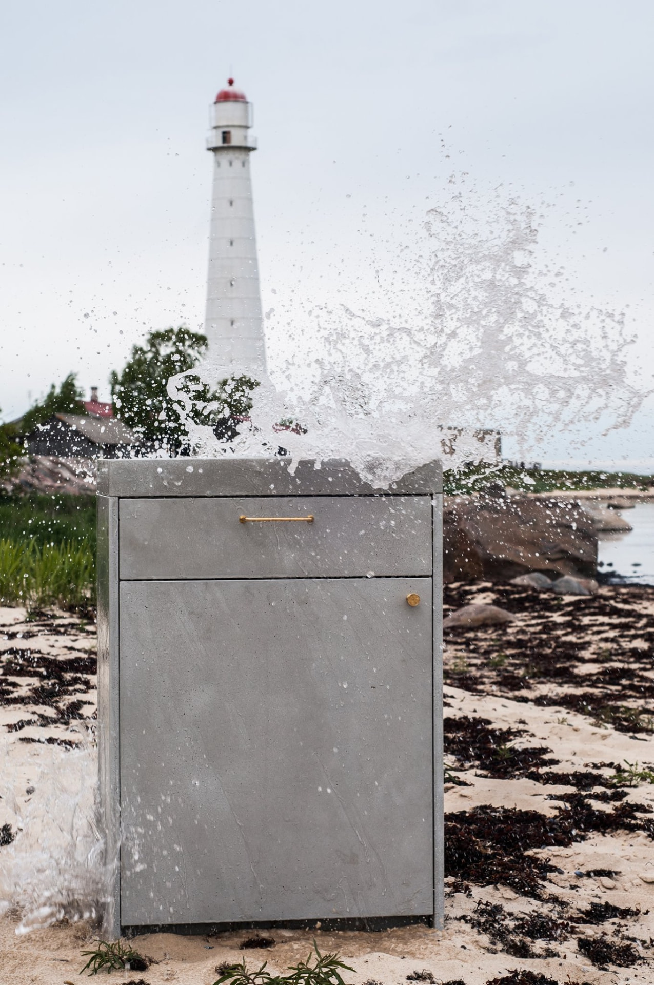 Concrete bathroom furniture with a bronze handle by the sea