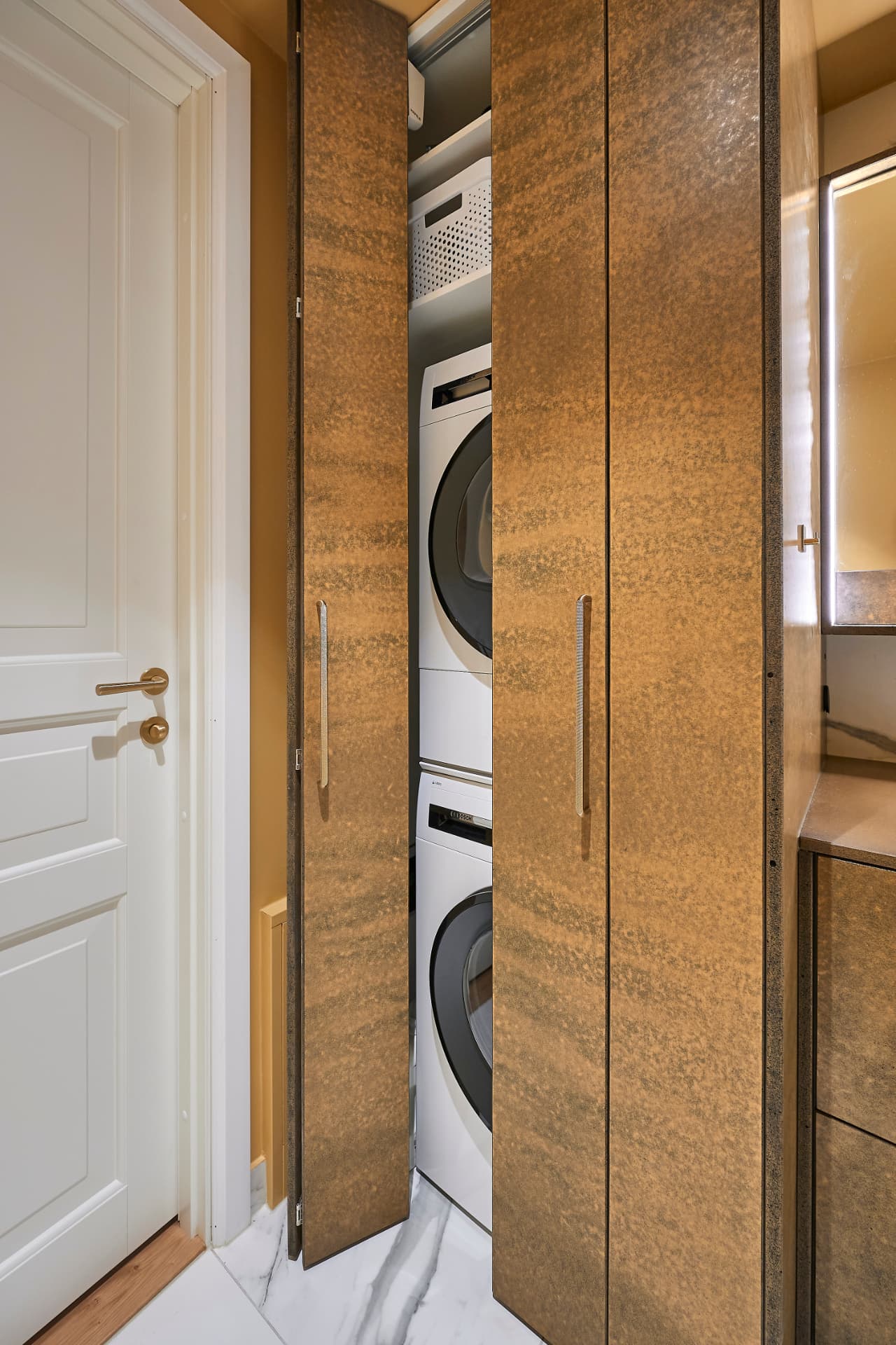 Golden utility cabinets that conceal the washing machine and dryer