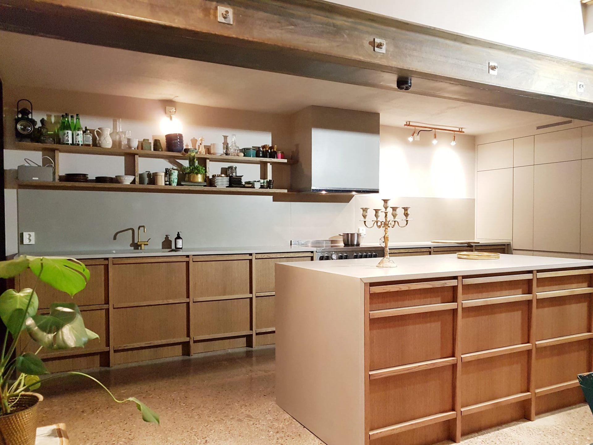 Oak kitchen with open shelving and a long kitchen island